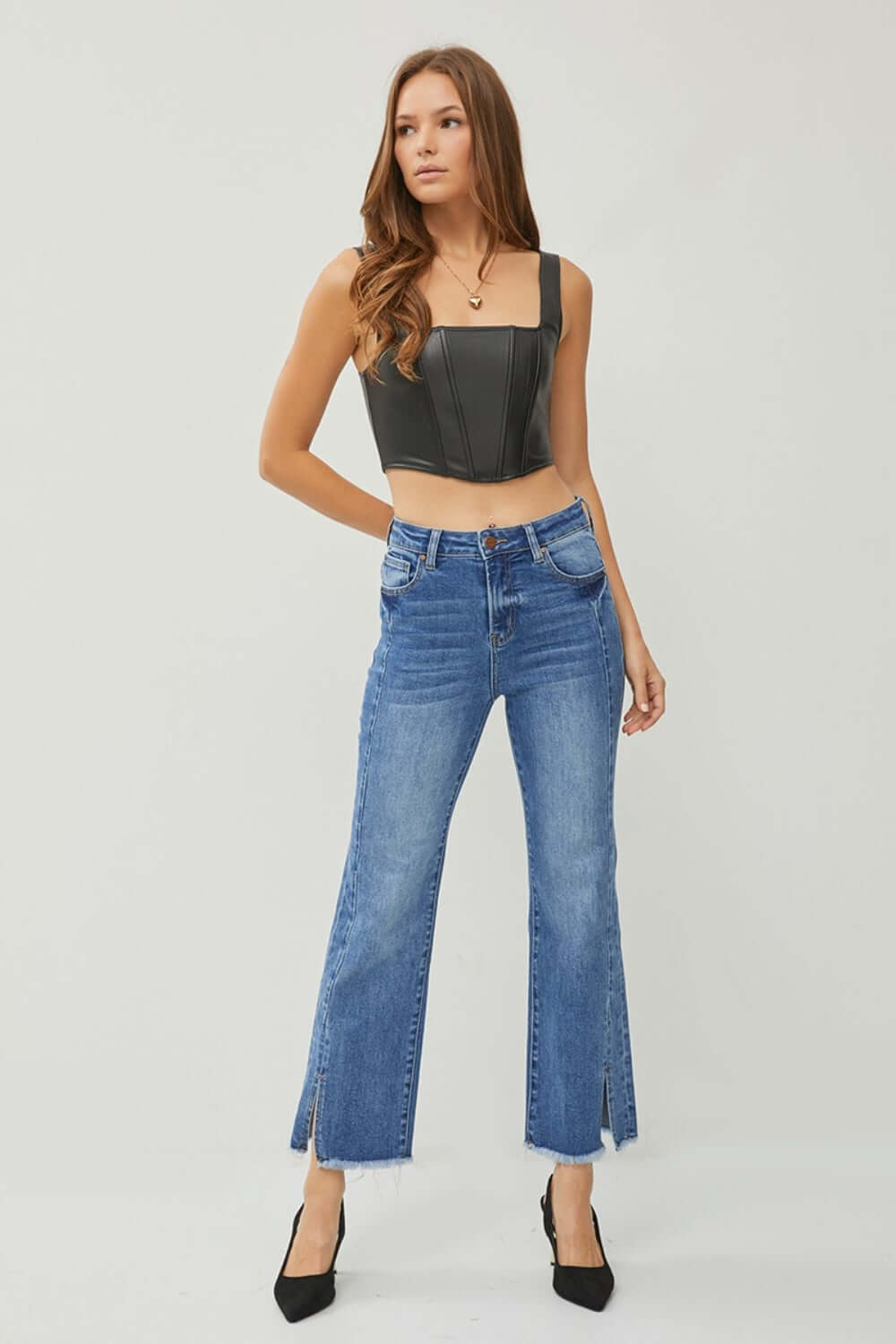 Model wearing High Waist Raw Hem Slit Straight Jeans by Risen Jeans, showcasing trendy, flattering fit with edgy raw hem and slit details