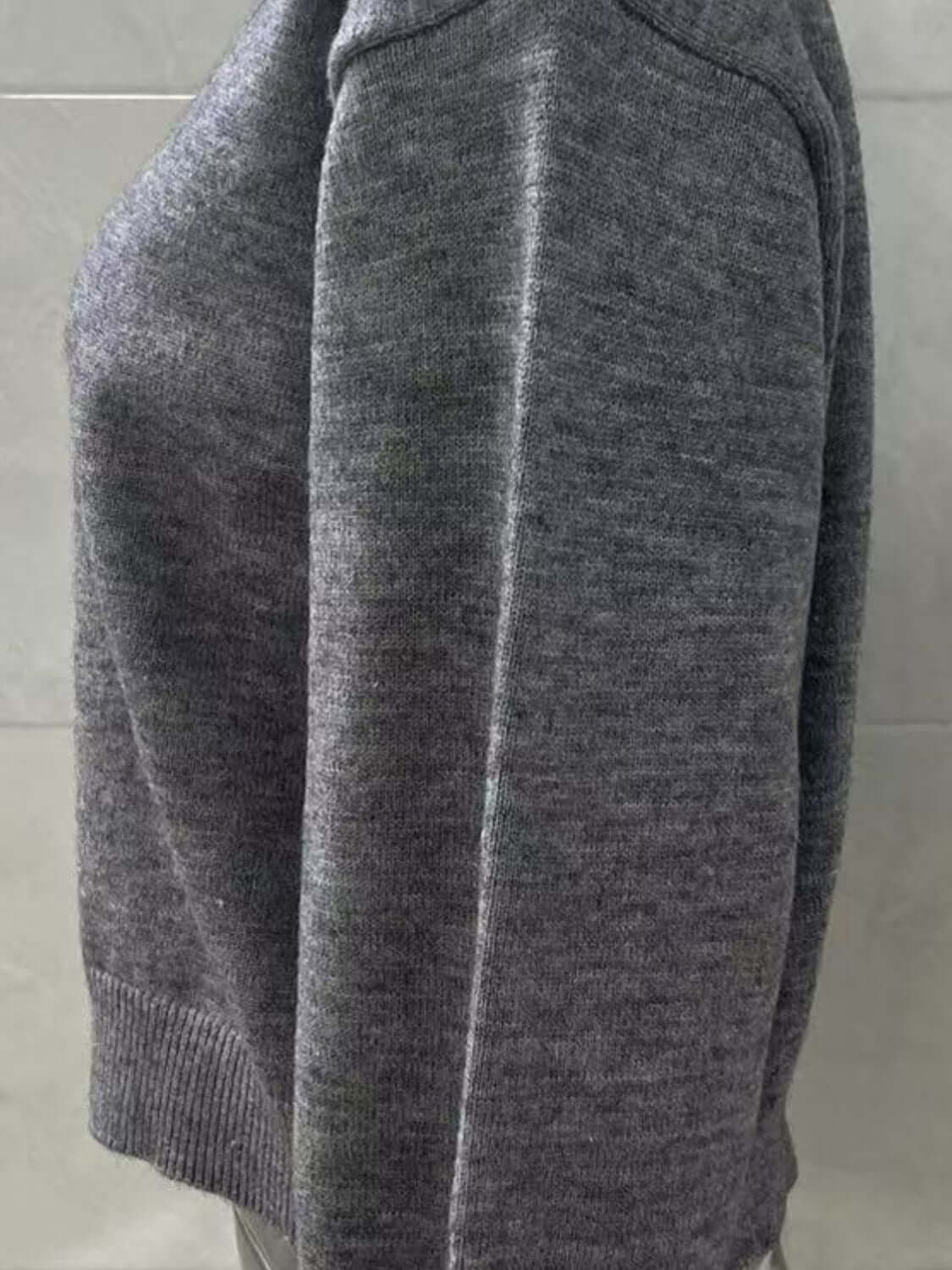 Side view of a cozy gray Bella Road Button Down Long Sleeve Cardigan, showcasing its soft texture and comfortable fit.