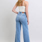 Judy Blue full-size wide leg jeans with pockets, styled with a fitted top and heels, showcasing a relaxed vintage look.