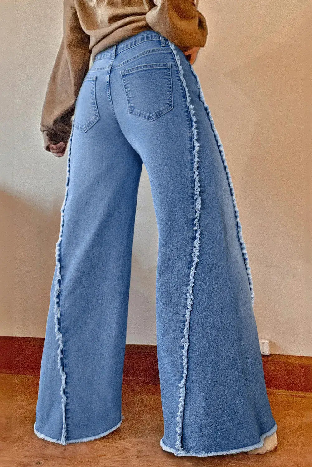 Back view of Bella Road Raw Hem Wide Leg Jeans with Pockets showing stylish raw hem and wide leg design