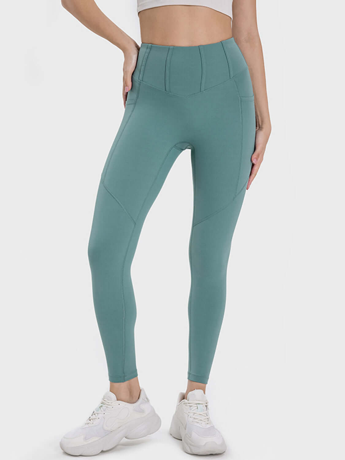 Millennia Pocketed High Waist Active Leggings in teal, designed for stylish and comfortable workouts with pockets.