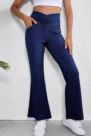 Woman wearing Asymmetric Waist Flare Jeans with pockets, showcasing stylish design and moderate stretch fabric in blue. Comfortable and trendy jeans.