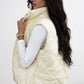 Woman wearing ivory Bella Road Snap Down Texture Vest Coat with Pockets, showcasing stylish fall/winter fashion.