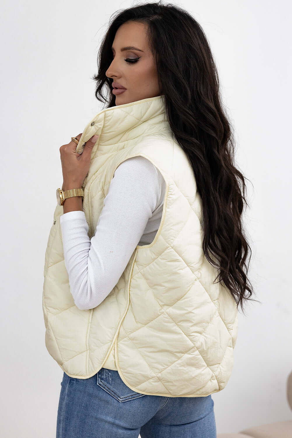 Woman wearing ivory Bella Road Snap Down Texture Vest Coat with Pockets, showcasing stylish fall/winter fashion.