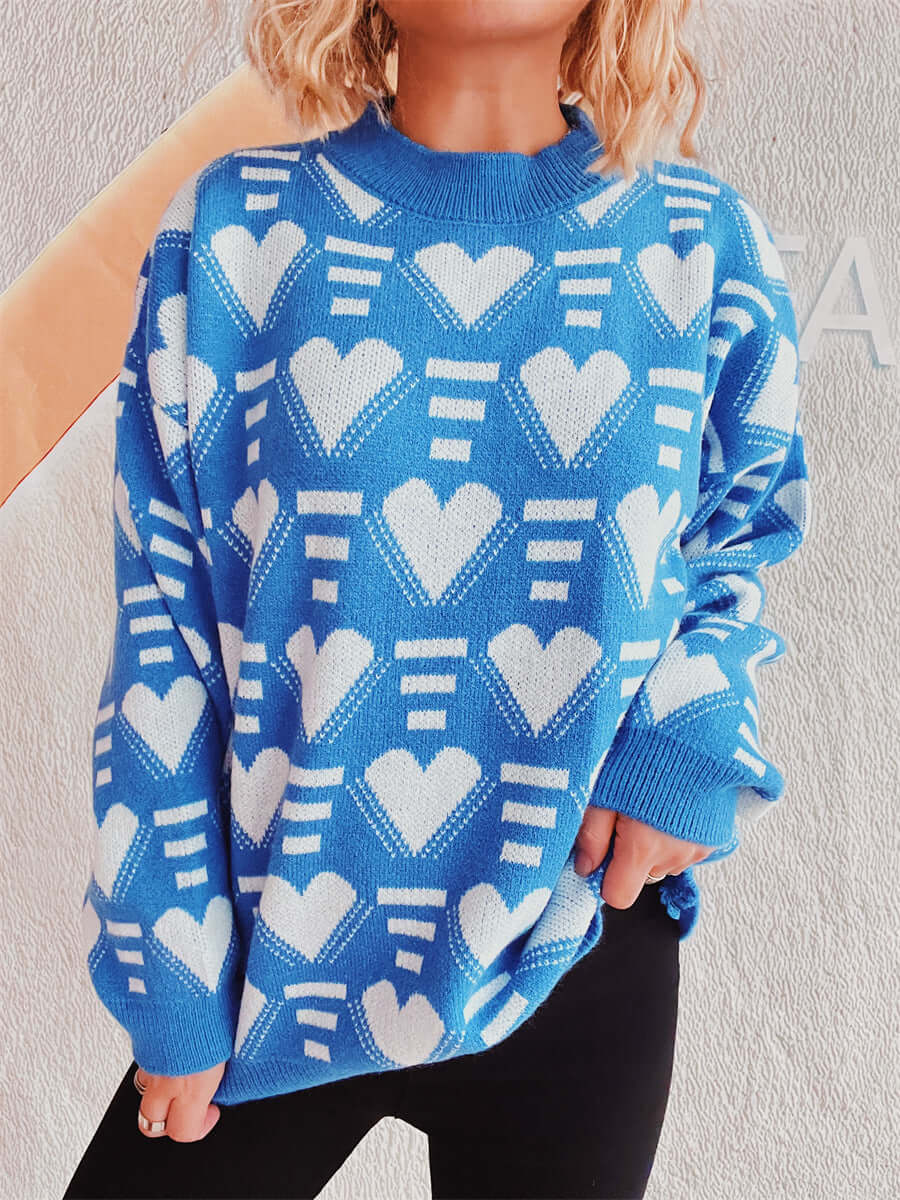 Woman wearing Bella Heart Contrast Long Sleeve Dropped Shoulder Sweater in blue with white hearts pattern.