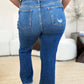 Back view of Judy Blue Full Size Mid Rise Distressed Raw Hem Jeans showing pockets and raw hem detailing.