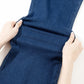 Demonstrating the stretch of blue straight jeans with pockets, showcasing the moderate stretchiness and comfortable material.