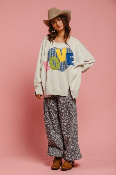 Model wearing BiBi LOVE Heart Patch Slit French Terry Sweatshirt with colorful LOVE patch and stylish boho pants.