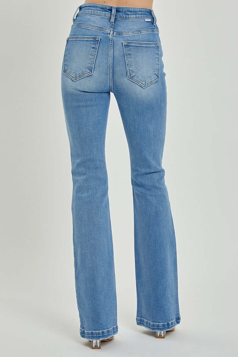 Back view of RISEN high rise button fly bootcut jeans showcasing flattering fit and vintage style in comfortable denim.