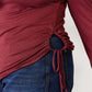 Close-up of drawstring detail on a maroon round neck long sleeve top with blue jeans