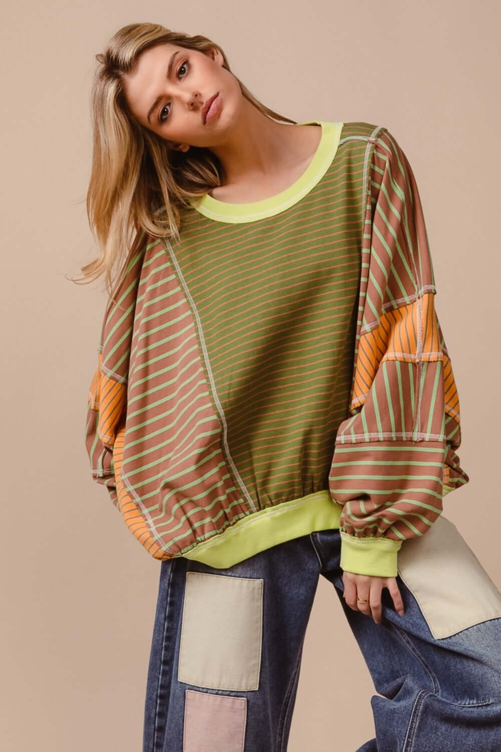 Trendy color block striped round neck sweatshirt in bold complementary colors, perfect for casual outings and style statements.