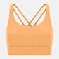 Millennia crisscross scoop neck active tank in vibrant orange, perfect for stylish workouts and comfort.