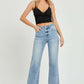 Woman wearing RISEN full size high-rise straight jeans with a black crop top, showcasing a chic and timeless silhouette.