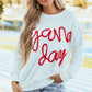 Woman wearing Bella Road Game Day Round Neck Long Sleeve Sweatshirt, showing team spirit in cozy and stylish sportswear.