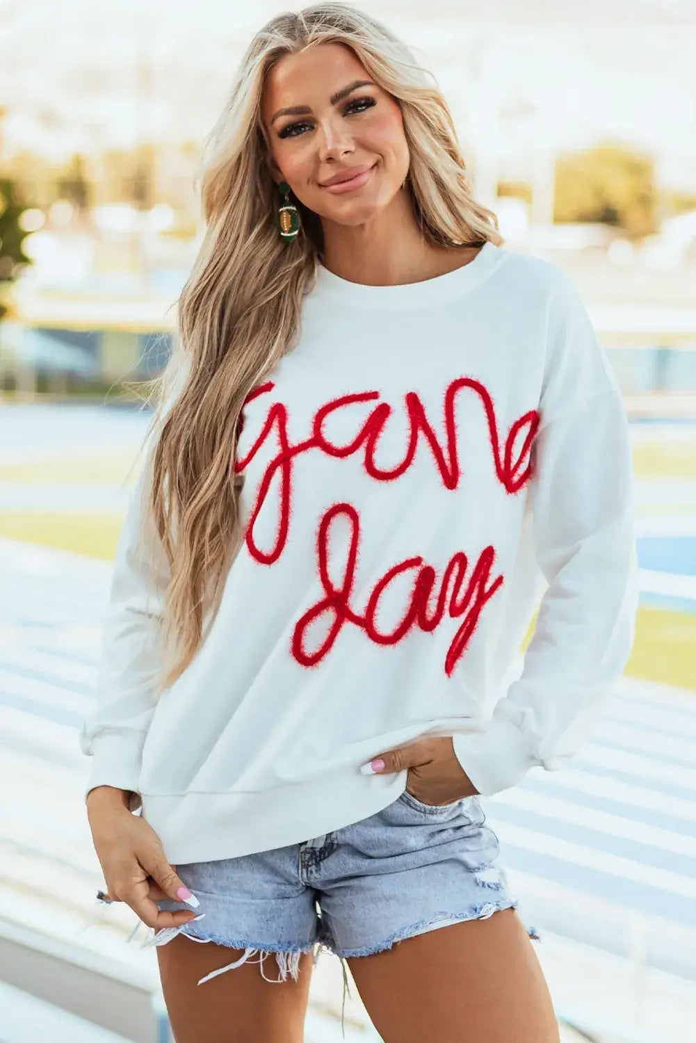 Woman wearing Bella Road Game Day Round Neck Long Sleeve Sweatshirt, showing team spirit in cozy and stylish sportswear.