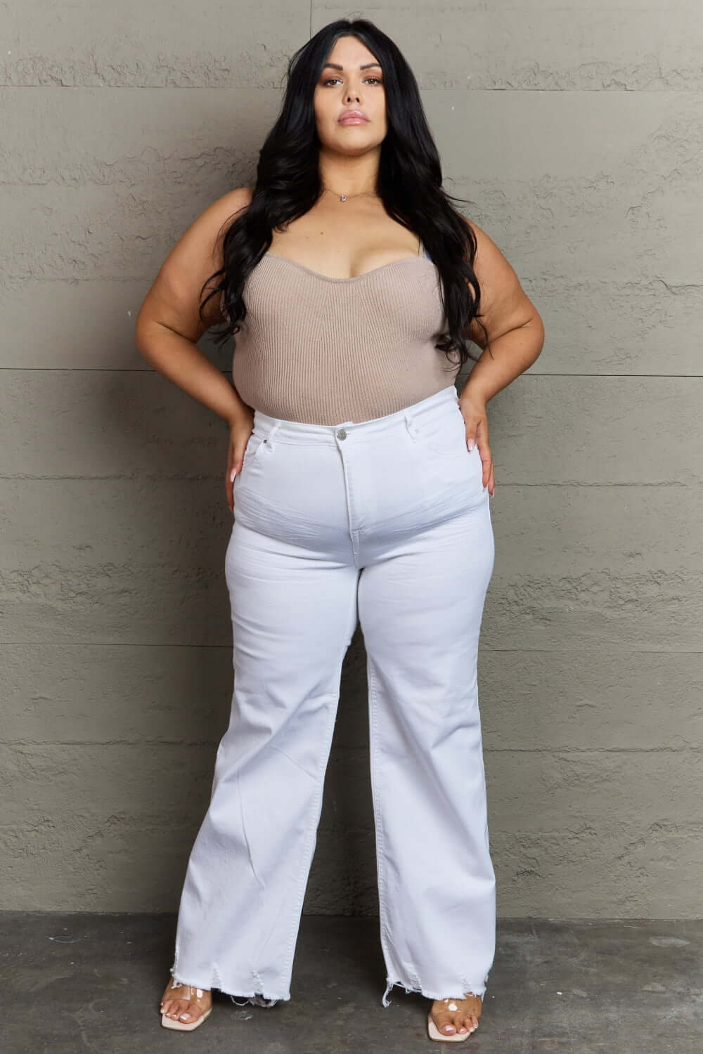 Woman wearing Raelene High Waist Wide Leg Jeans in White, showcasing a chic and modern look with a flattering high-rise waistline. Risen Jeans.