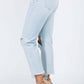 High Waist Distressed Raw Hem Jeans in light wash, featuring a flattering fit and trendy distressed details, worn with beige high heels.