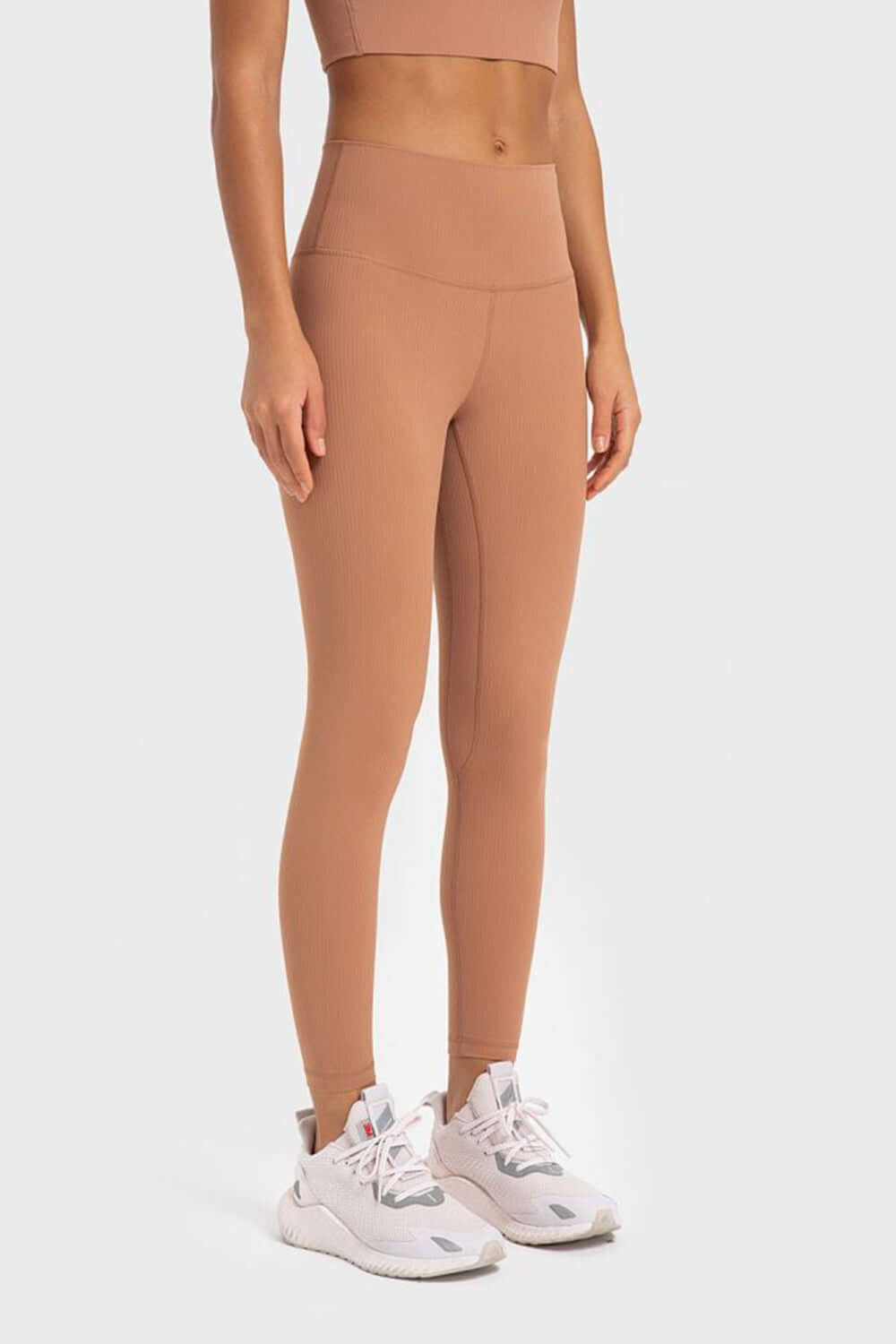 Model showcasing Millennia Highly Stretchy Wide Waistband Yoga Leggings in a warm nude color, perfect for yoga and workouts.