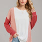 Woman wearing Double Take Texture Contrast Round Neck Long Sleeve T-Shirt in trendy color combo, perfect for layering.