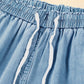 Close-up of the drawstring waistband on Bella Road light wash denim cargo wide leg jeans.