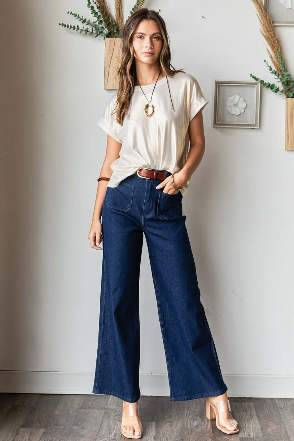 Woman wearing Mittoshop High Waist Wide Leg Jeans and white top, showcasing a chic and comfortable fashion ensemble.