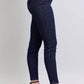 Heart-shaped back pockets skinny jeans in dark denim, side view showing high-rise fit and stylish design, paired with heels.