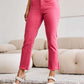 Woman wearing Crop Dylan Full Size Tummy Control High Waist Raw Hem pink Jeans, adding a stylish touch to her outfit. RFM Jeans