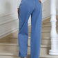 Back view of Bella Road High Waist Straight Leg Jeans with Pockets in blue denim, worn by a woman.