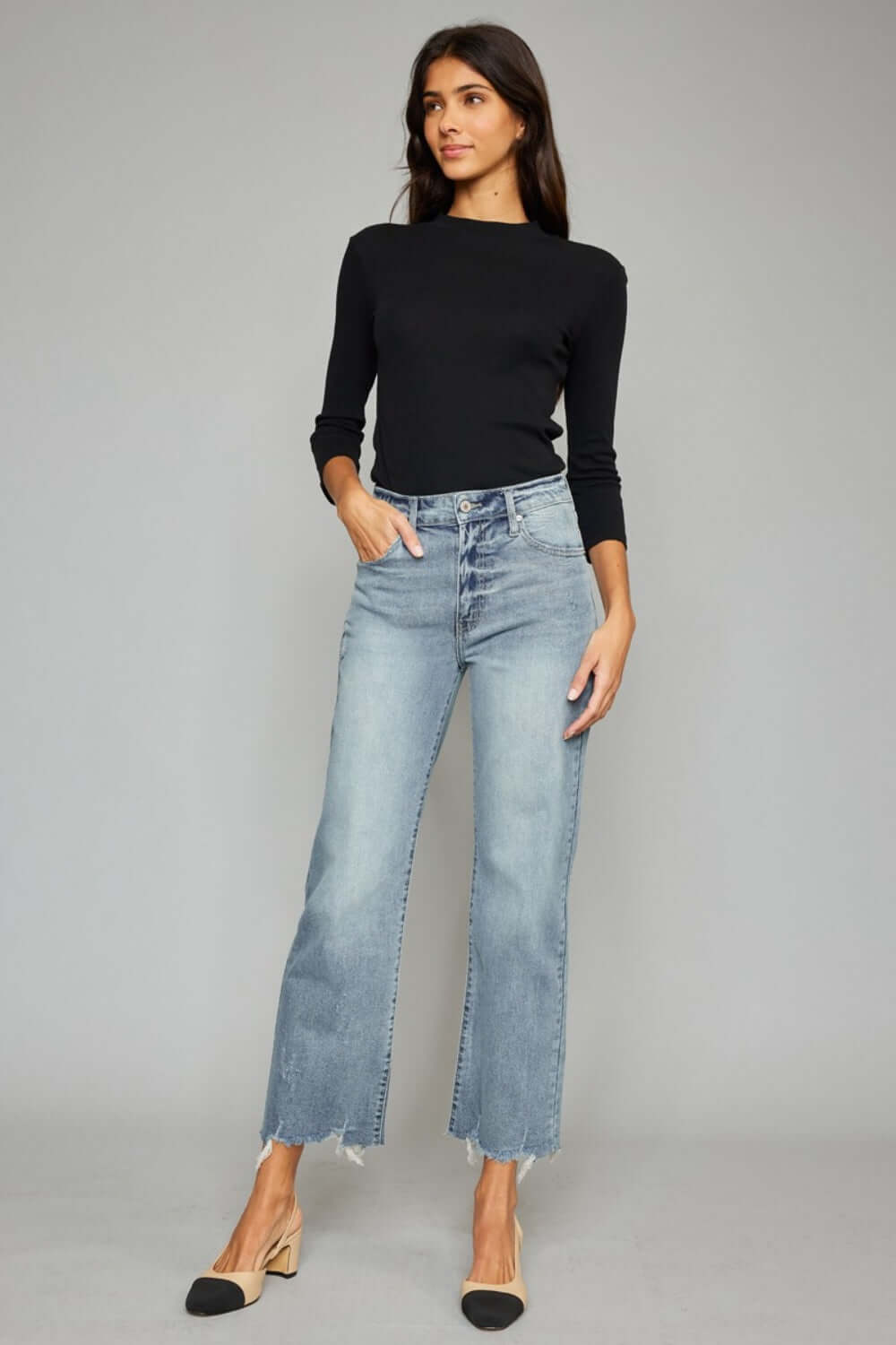 High Waist Raw Hem Cropped Wide Leg Jeans on model, featuring a trendy high waist design, wide leg style, and edgy raw hem detailing.