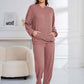 Woman in dusty pink Bella Road hoodie and pants set, cozy and stylish with pockets, perfect for lounging or errands.