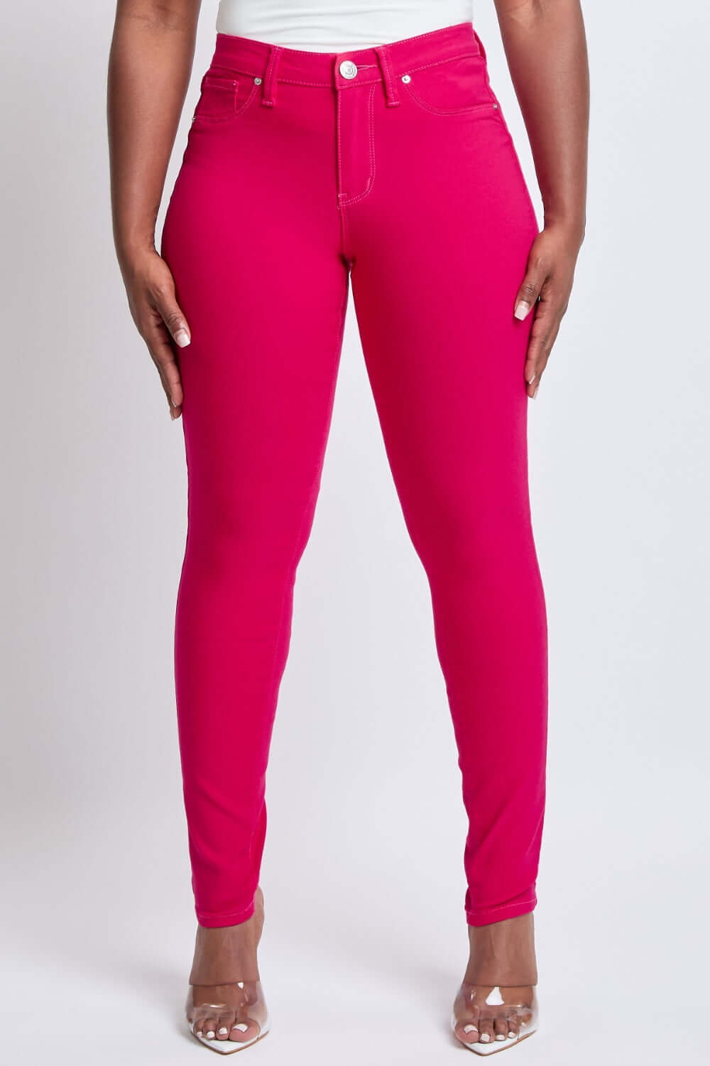 Hyperstretch Mid-Rise Skinny Jeans in vibrant pink, styled with a comfortable and flattering fit, perfect addition from YMI Jeans