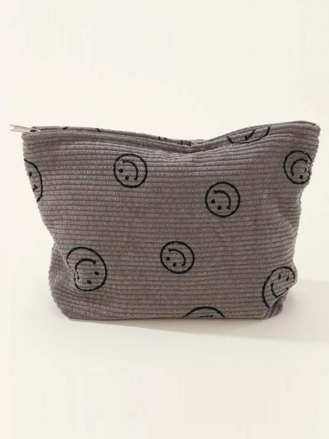 Stylish Zenana corduroy clutch bag with cute smiley face print, perfect for casual or semi-formal occasions.