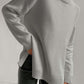 Cozy turtleneck sweater with side slits and dropped shoulders in gray, perfect for stylish warmth and comfort.