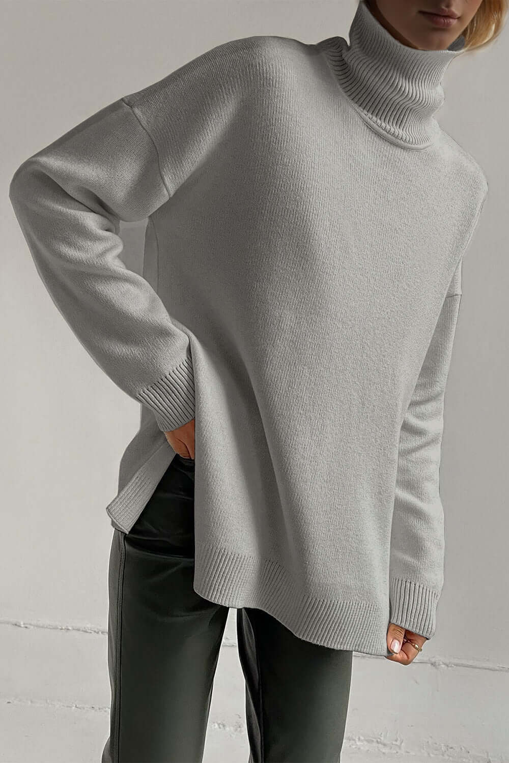 Cozy turtleneck sweater with side slits and dropped shoulders in gray, perfect for stylish warmth and comfort.