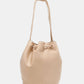 Nicole Lee USA Amy Studded Bucket Bag in beige vegan leather with drawstring closure and subtle stud detailing.