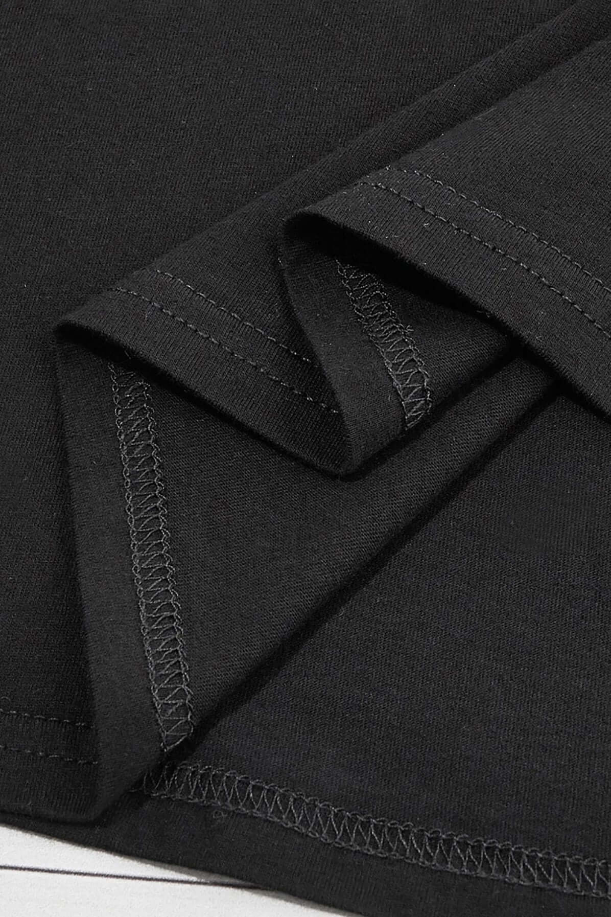 Close-up of the black fabric and stitching details of the Bella Road graphic T-shirt, showcasing its quality and finish.