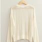 Openwork ribbed trim long sleeve knit top in white on hanger