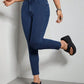 Woman wearing Bella Road Skinny Jeans with Pockets, dark blue, stylish and stretchy fit, paired with black platform sandals.