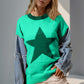 Woman wearing Double Take Full Size Star Pattern Raw Edge Long Sleeve Sweater in green with denim sleeves and shorts.