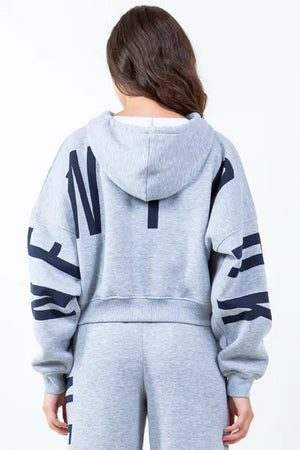 Back view of American Bazi 'New York' graphic cropped hoodie with drawstrings, showcasing its trendy design.