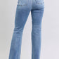 Judy Blue high rise bootcut jeans with raw hem, featuring a flattering fit and stylish vintage-inspired look.