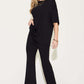 Woman wearing black Bamboo Drop Shoulder T-Shirt and Flare Pants Set with brown heels.