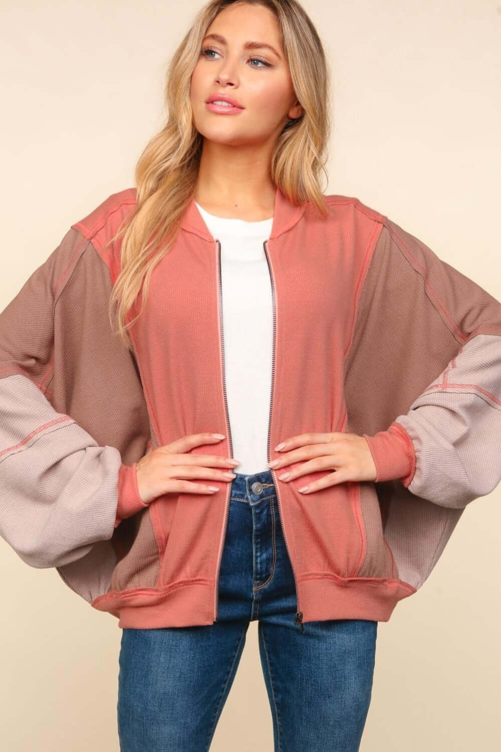 Trendy color block bomber jacket with zip-up front and side pockets, perfect for layering over casual outfits.