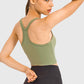 Stylish model showcasing the Millennia Racerback Sports Bra in olive green, perfect for yoga and active workouts.