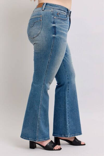 Side view of Judy Blue Mid Rise Tummy Control Vintage Wash Jeans, showcasing a flattering fit and retro style.