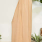 Side view of wrap pleating detail wide leg pants in beige, showcasing modern elegance and chic wide leg silhouette.