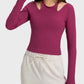 Woman wearing a stylish halter neck long sleeve sporty top in burgundy, perfect for workouts and casual outings.