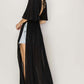 Black tie back maxi split cover up dress with plunging neck, batwing sleeves, and cinched waist highlighting curves and side slits.