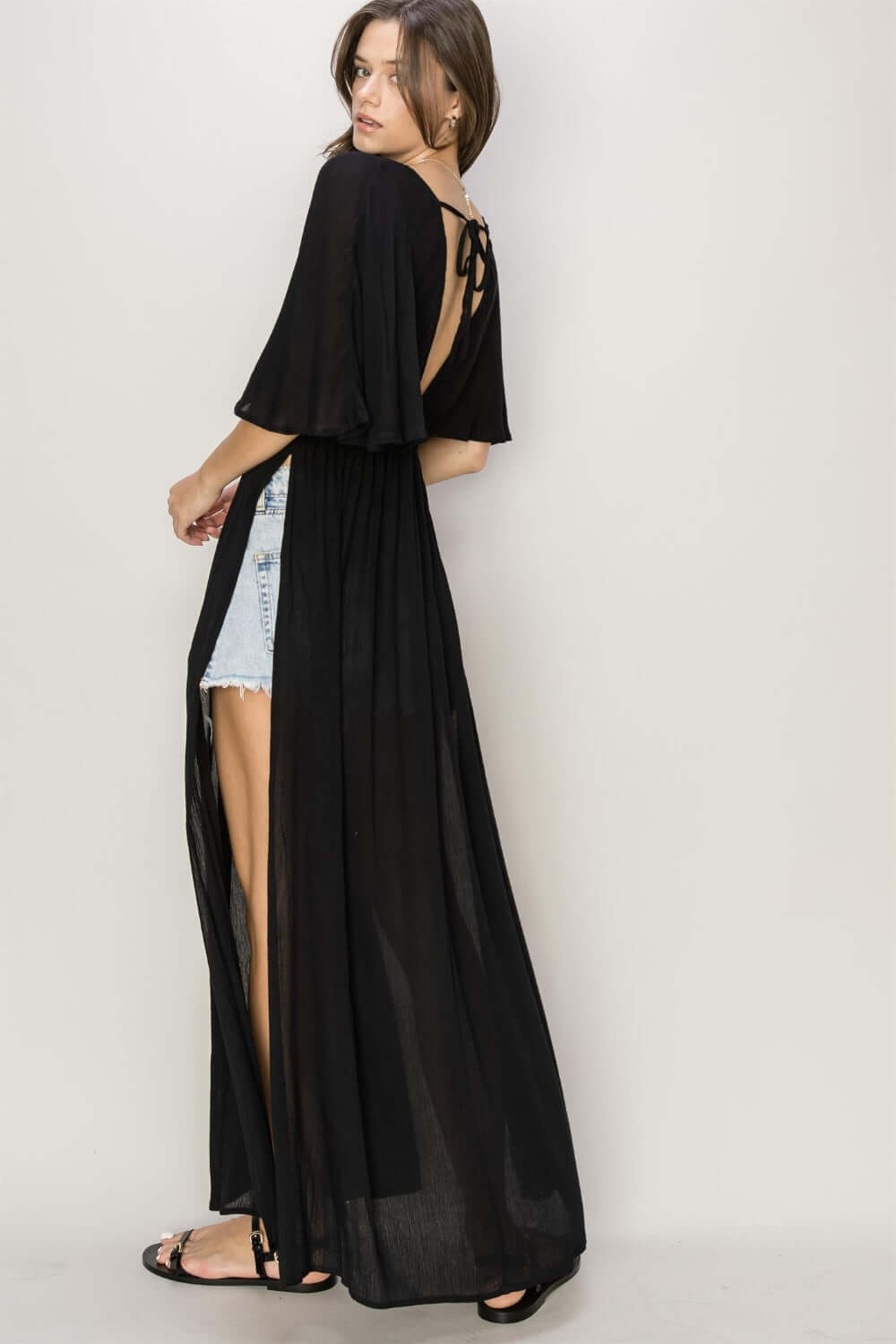 Black tie back maxi split cover up dress with plunging neck, batwing sleeves, and cinched waist highlighting curves and side slits.