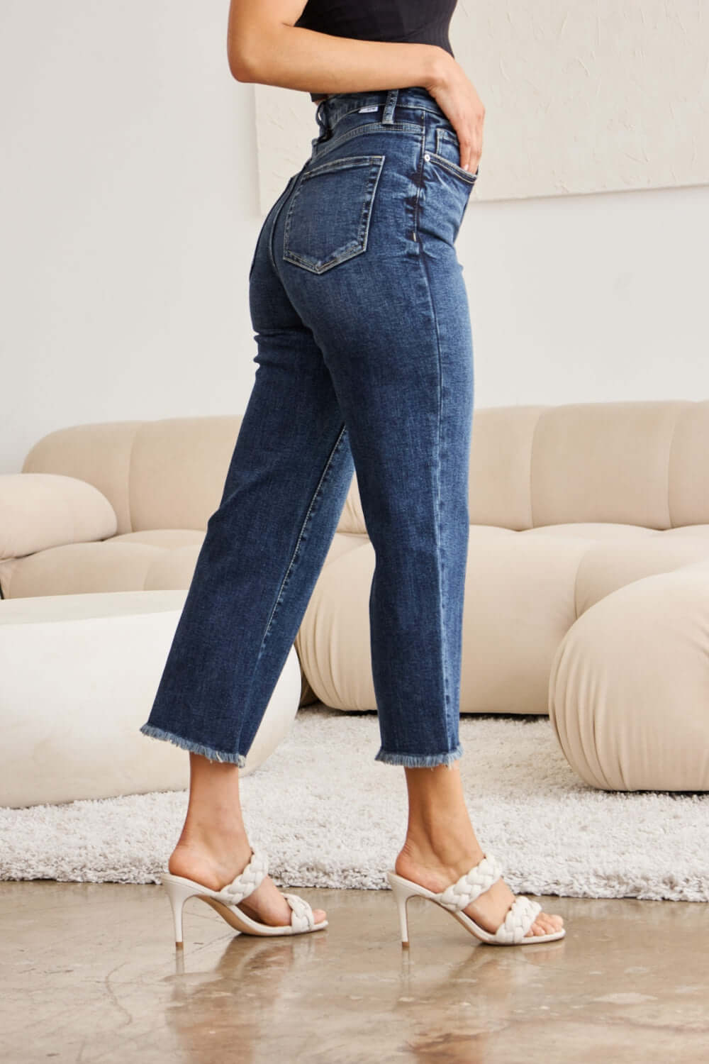 Woman wearing Tummy Control High Waist Raw Hem Distressed Jeans with heels, showing the stylish and slimming fit of RFM Jeans.